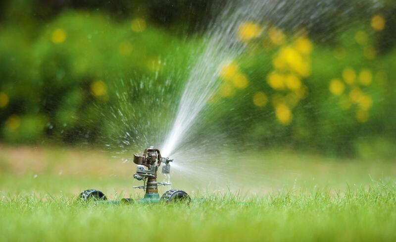 water sprinkler system working in lawn 